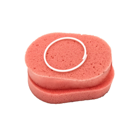 Two peach-colored oval foam sponges with a white circular C-shaped plastic ring on top