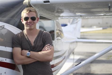 Matthew Shope standing confidently beside a light aircraft