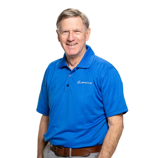 Boeing Signature Omega mesh tech polo worn by model in royal blue with embroidered Boeing logo