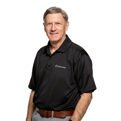 Boeing Signature Omega mesh tech polo worn by model in black with white Boeing logo