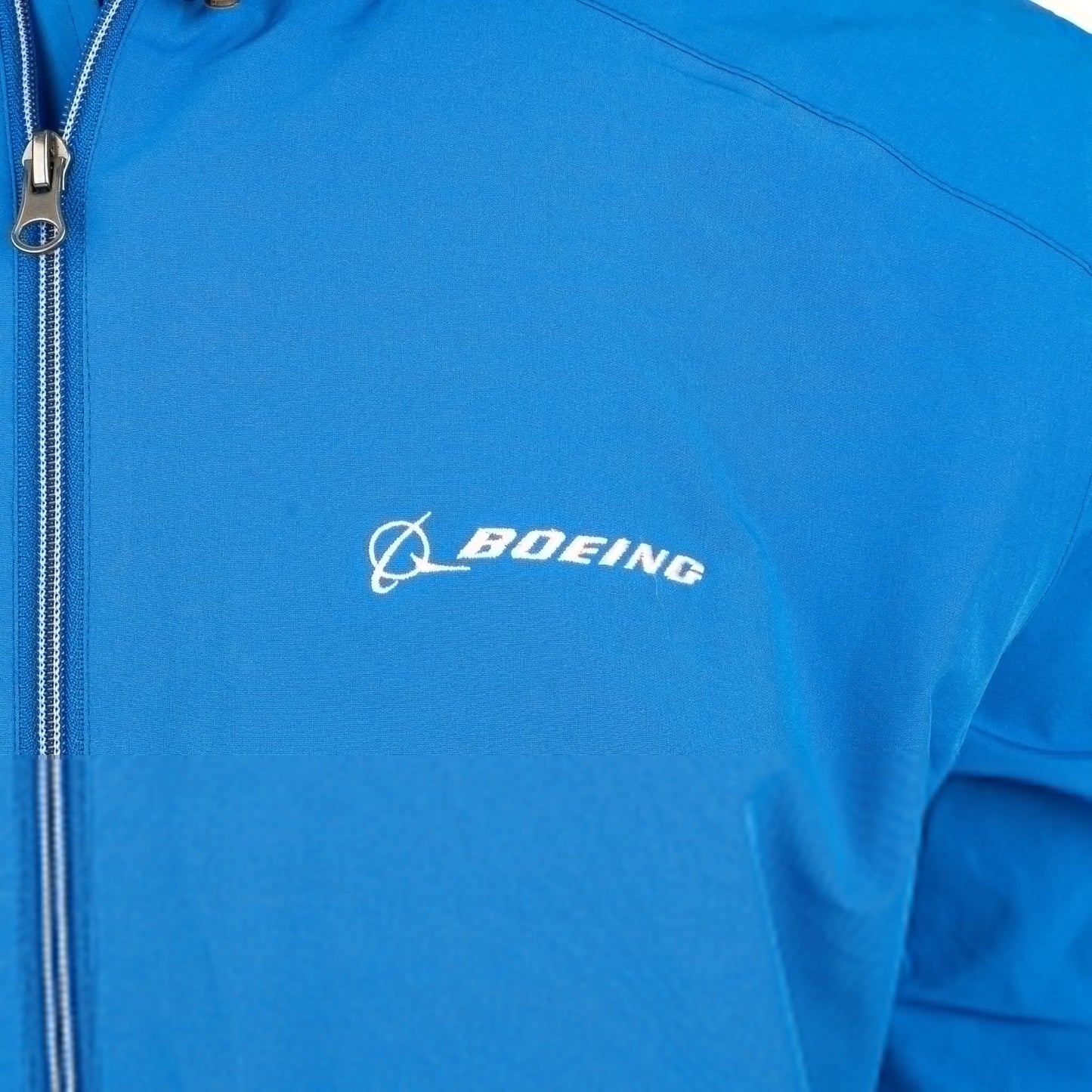 Close-up of embroidered Boeing logo on royal blue Newport jacket chest