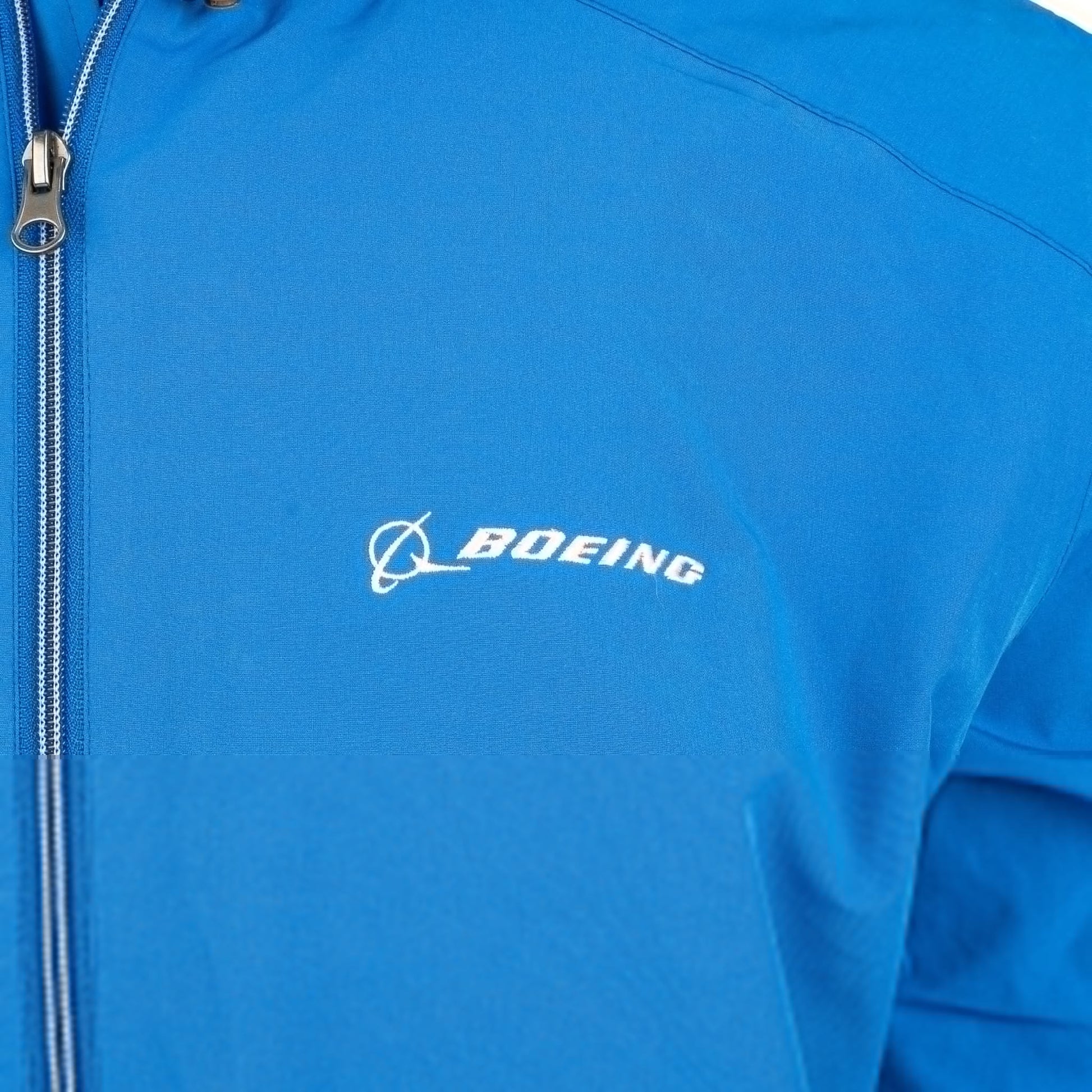 Close-up of embroidered Boeing logo on royal blue Newport jacket chest