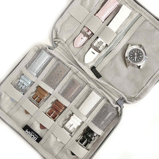 Open travel watch and strap organizer pouch showing multiple watch straps and a timepiece stored securely.