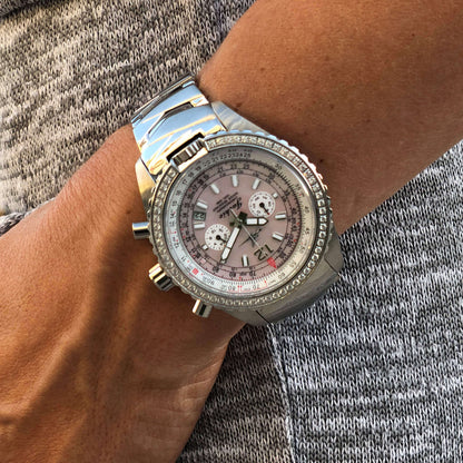 Jackie Women's Pilot Watch with Sunset Pink Mother-of-Pearl Dial, Stainless Steel Band, and Swarovski Bezel Shown on Wrist in Outdoor Setting