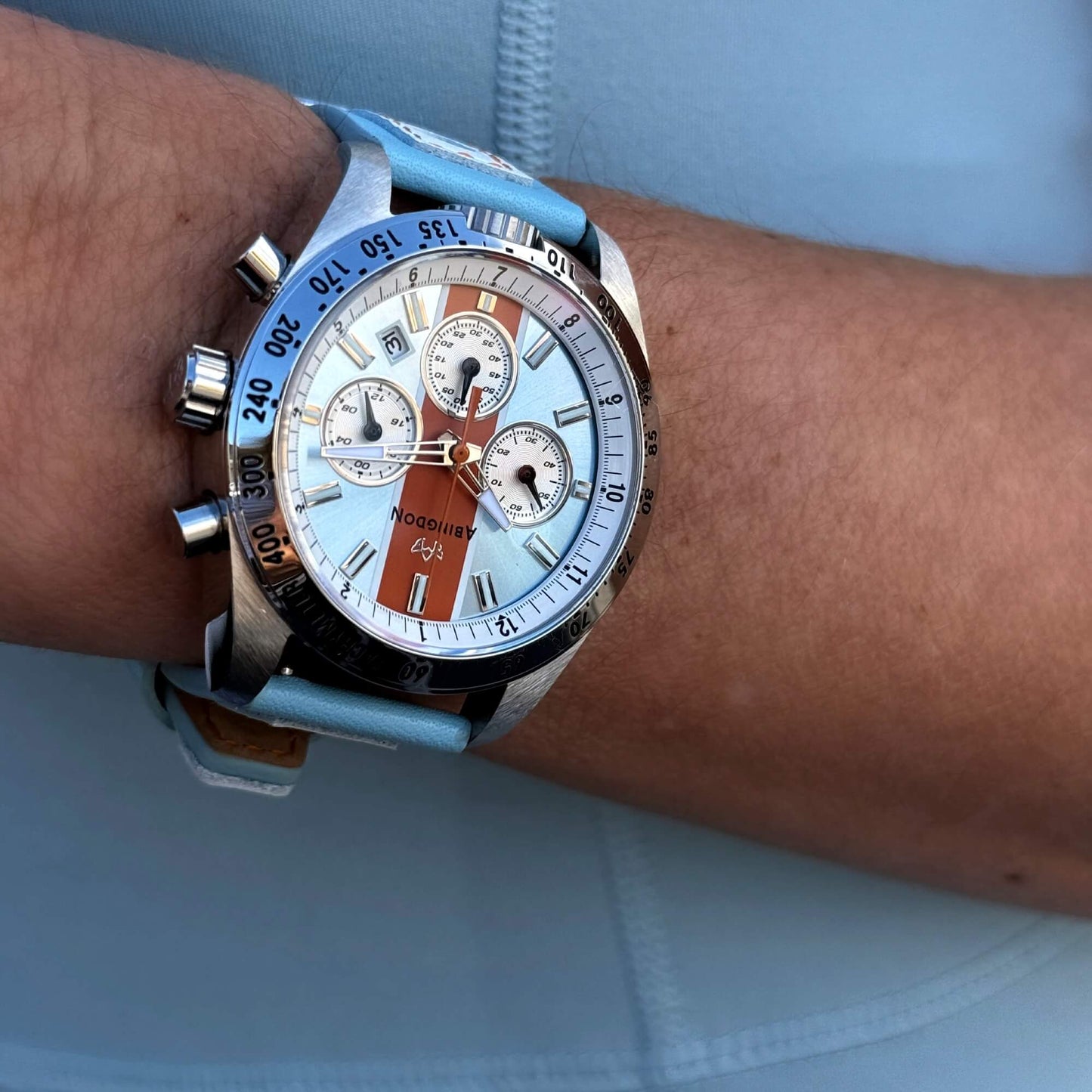 Jordan Women’s Pilot Watch with Gulfhawk Light Blue Dial, Orange Racing Stripe, Blue Leather Strap, Shown on Wrist with Chronograph and Tachymeter Bezel