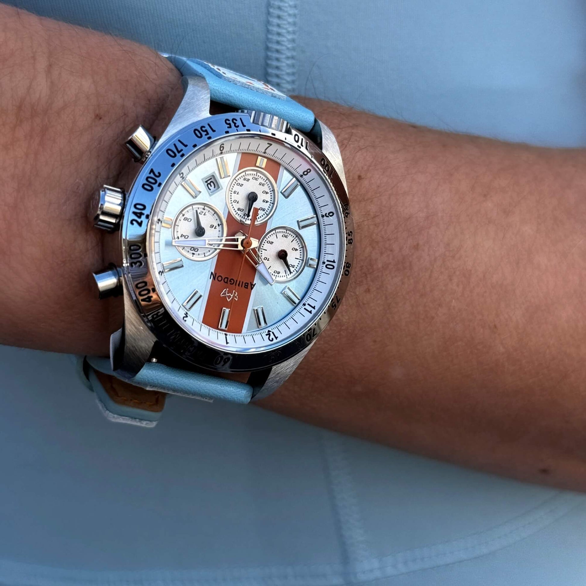 Jordan Women’s Pilot Watch with Gulfhawk Light Blue Dial, Orange Racing Stripe, Blue Leather Strap, Shown on Wrist with Chronograph and Tachymeter Bezel