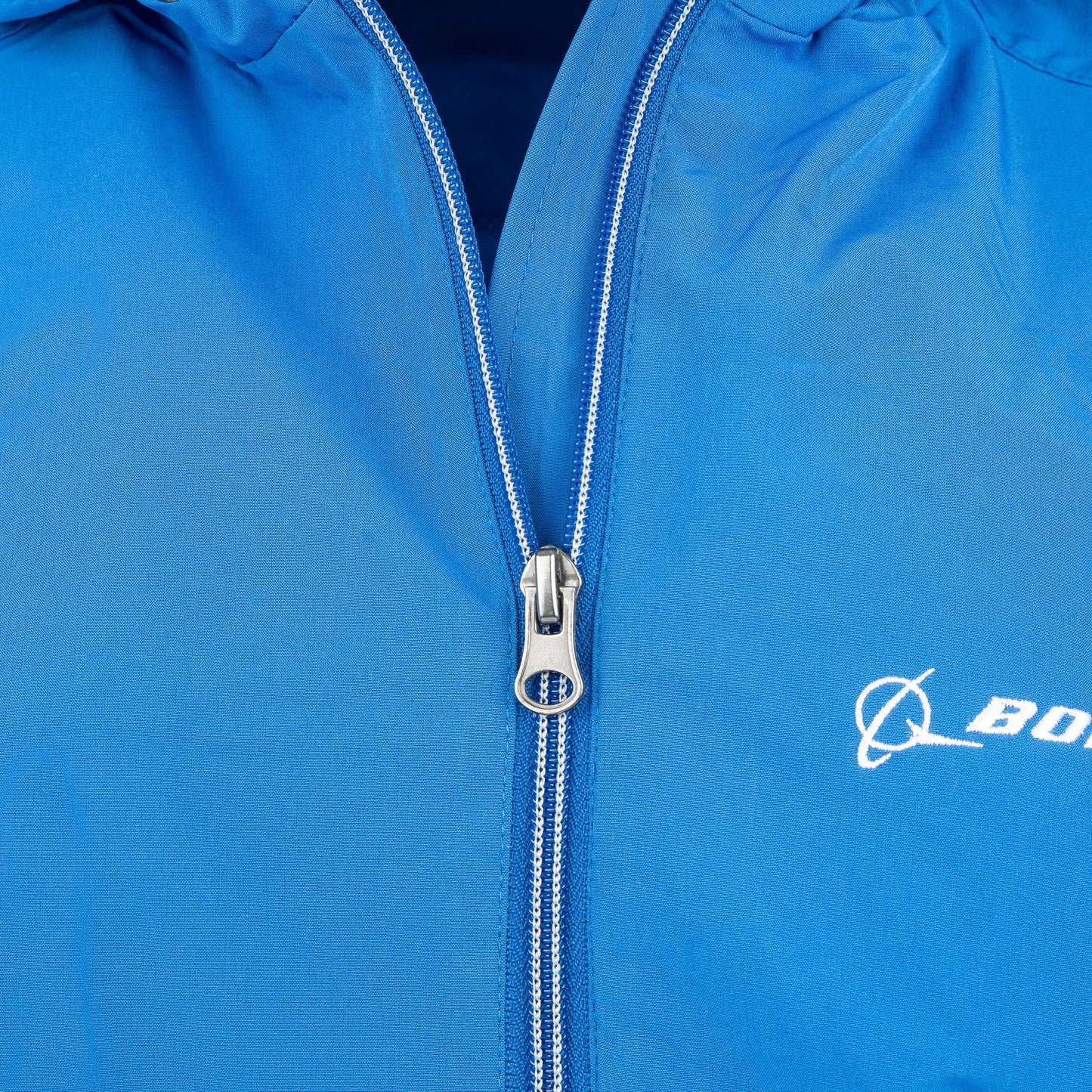 Close-up of royal blue Boeing Newport Jacket zipper and embroidered chest logo