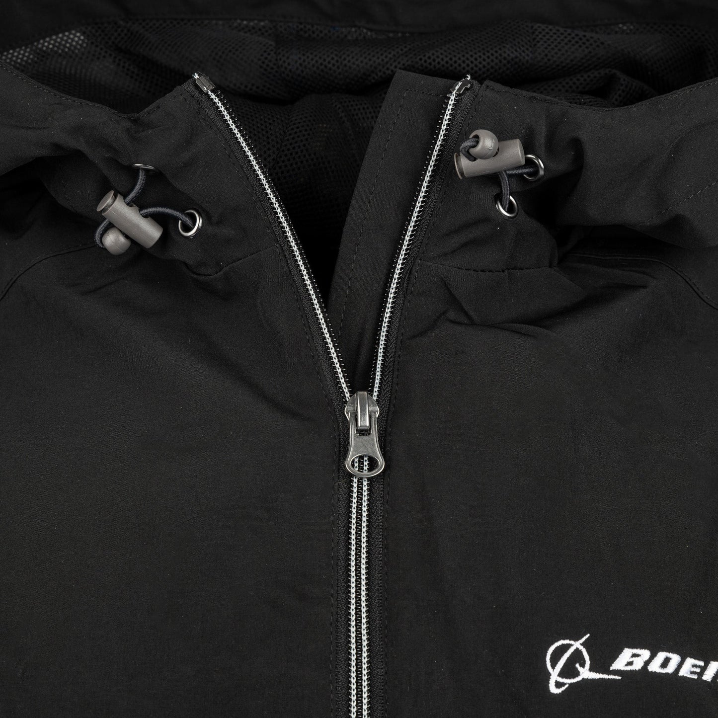 Close-up of black Boeing Newport Jacket hood drawcord and front zipper detail