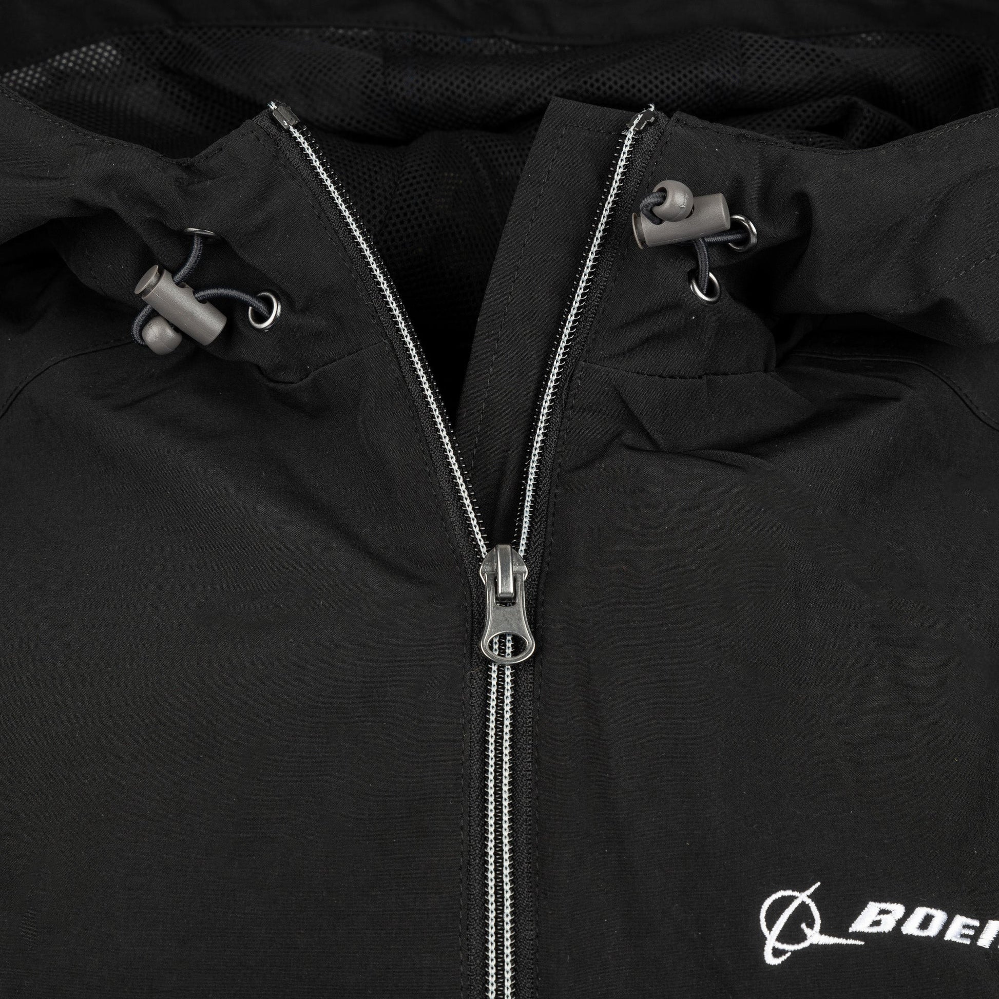 Close-up of black Boeing Newport Jacket hood drawcord and front zipper detail