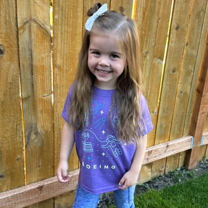 Toddler wearing purple Boeing Space Doodle T-Shirt with astronaut and space station design