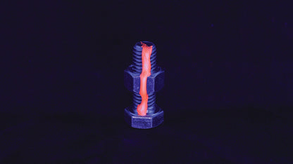 Dykem Cross Check FAST Orange applied on fastener, glowing under UV light