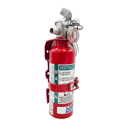 Side view of H3R Aviation A344T Halon 1211 fire extinguisher secured in red mounting bracket with instruction label visible