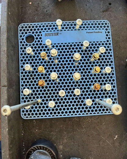 Light blue Boltster Original Organizer holding mixed-length bolts in a precise configuration, displayed on a metal work surface.