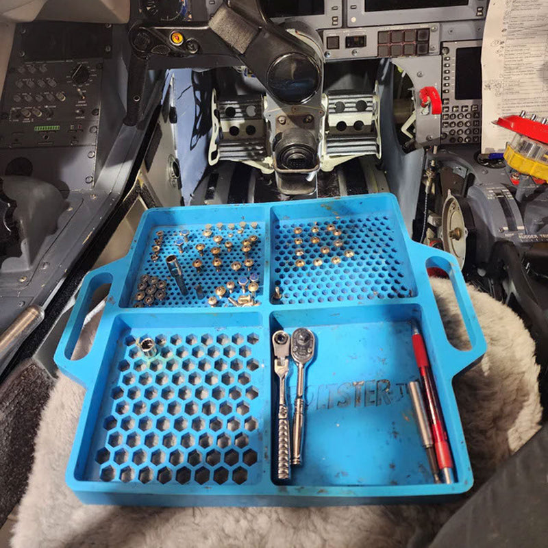Boltster™ Flexible Organizing Tray in blue holding tools and fasteners inside an aircraft cockpit during maintenance
