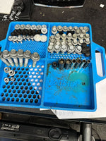 Blue Boltster™ Flexible Organizing Tray filled with large bolts and fasteners on a workbench during mechanical disassembly