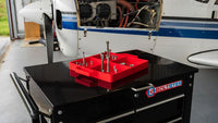 Red Boltster™ Flexible Organizing Tray holding fasteners on a tool chest during aircraft maintenance in a hangar