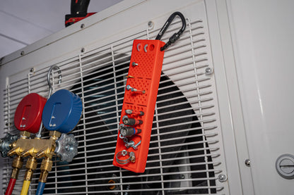 Red Bitster 2.0 fastener organizer hanging on HVAC unit with screws, bits, and clips