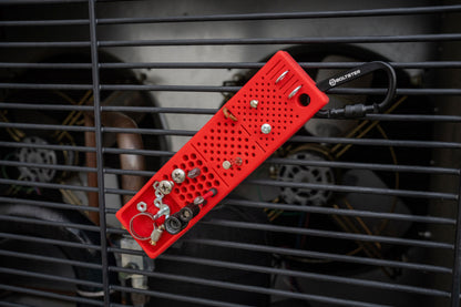 Red Bitster 2.0 magnetic fastener organizer with clip holding assorted hardware on metal vent