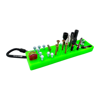 Green Boltster Bitster 2.0 silicone organizer for bits, screws, and fuses, featuring a belt clip and magnetic base.