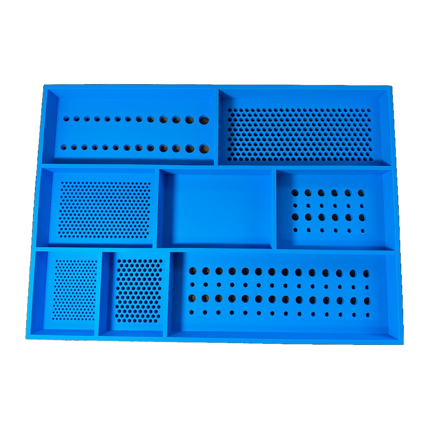 Top-down view of the Boltster™ Top Box Tool Tray in blue silicone, showing five hole patterns, linear sections, and a central catch-all compartment