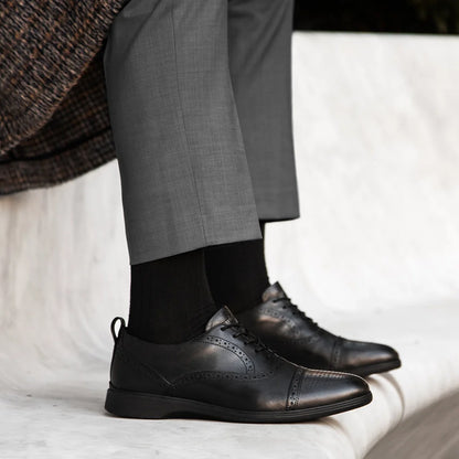 Amberjack Cap-Toe Obsidian black pilot oxford dress shoe, left side view, cap-toe lace-up | Lifestyle Sitting