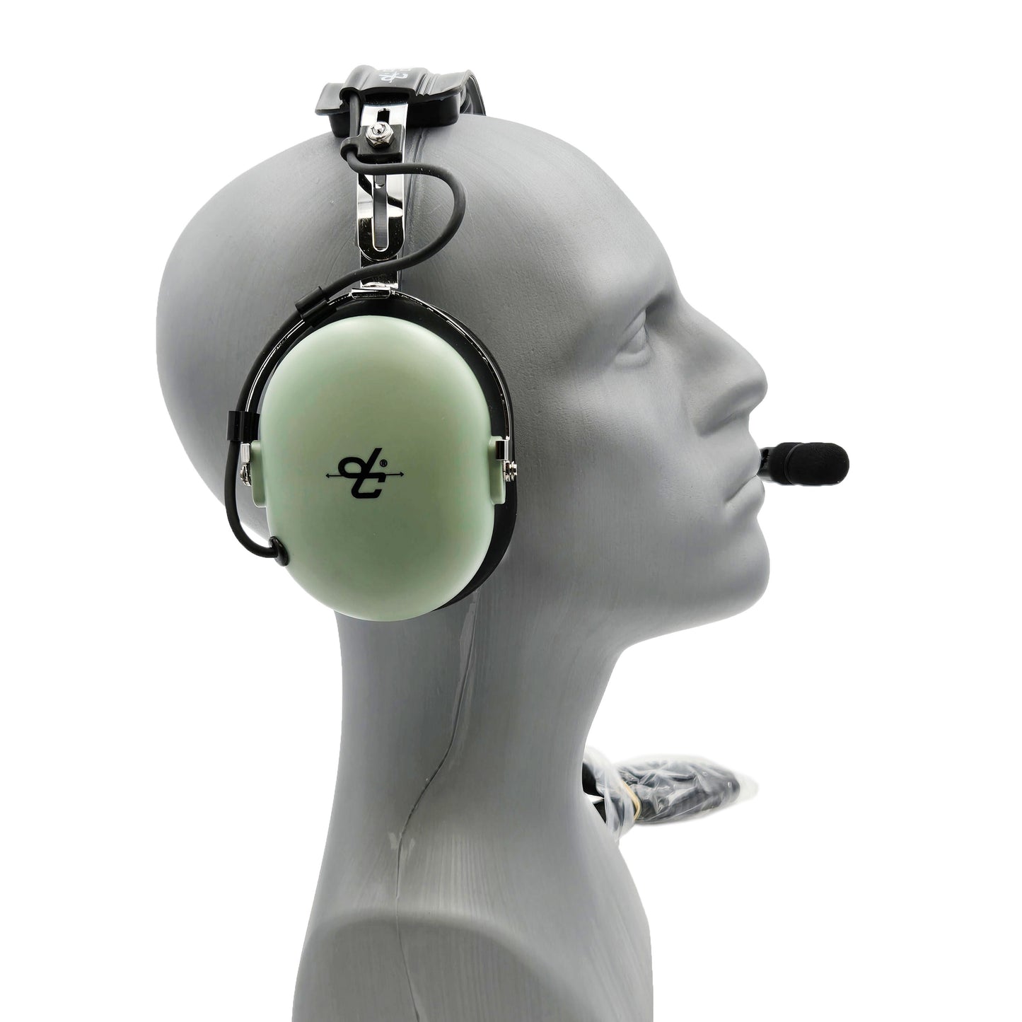 Right-side profile of David Clark H3432 headset showing green ear cup with dc logo, metal headband hardware, and boom microphone mount
