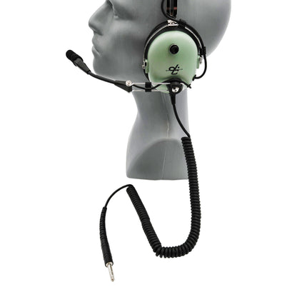 Left-side profile of David Clark H3432 headset showing volume adjustment knob and long coiled cord with 1/4-inch plug