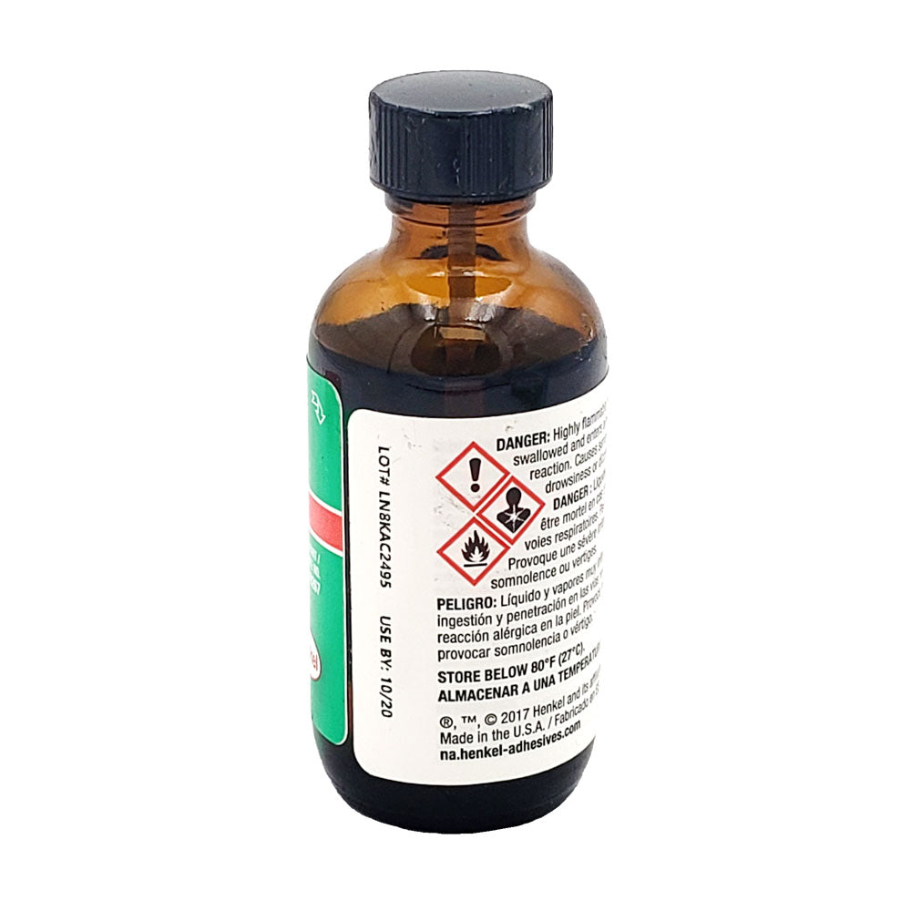 Side view of Loctite 7471 primer bottle showing lot number LN8KAC2495, use-by date, and GHS hazard symbols for flammability and health warnings.