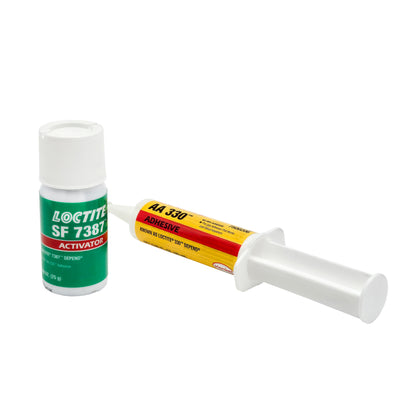 Side-by-side view of expired Loctite 330 Adhesive syringe and SF 7387 Activator bottle showing distinct color-coded labels.