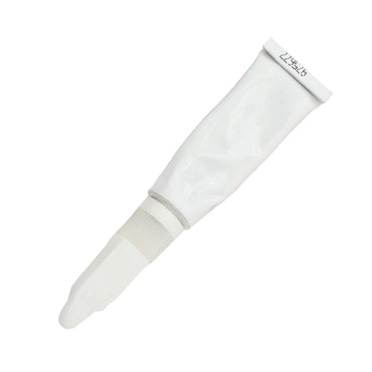 Back view of expired Vibra-Tite 354 Super Glue Gel 3g tube showing plain white surface, crimped end, and printed lot code.