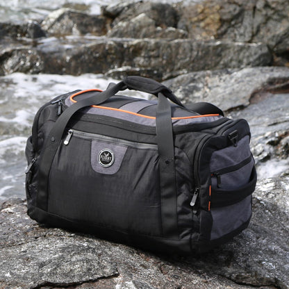 Flight Outfitters Crew Duffel Bag on rocky surface, angled view
