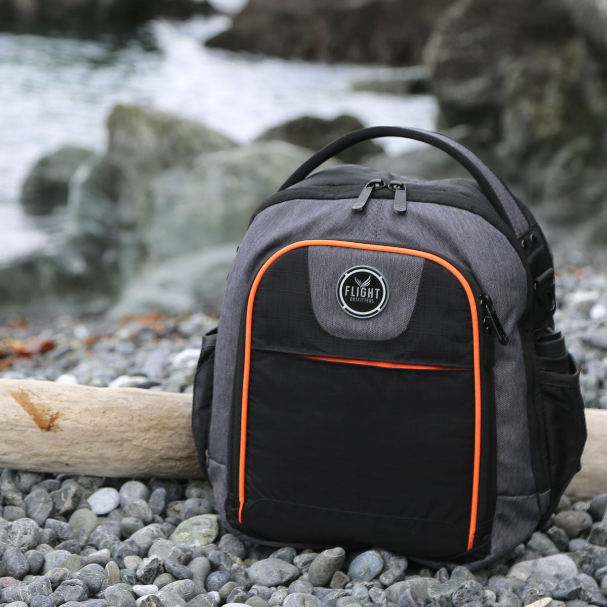 Lifestyle image of Flight Outfitters Lift Flight Bag 2.0 on a river bank