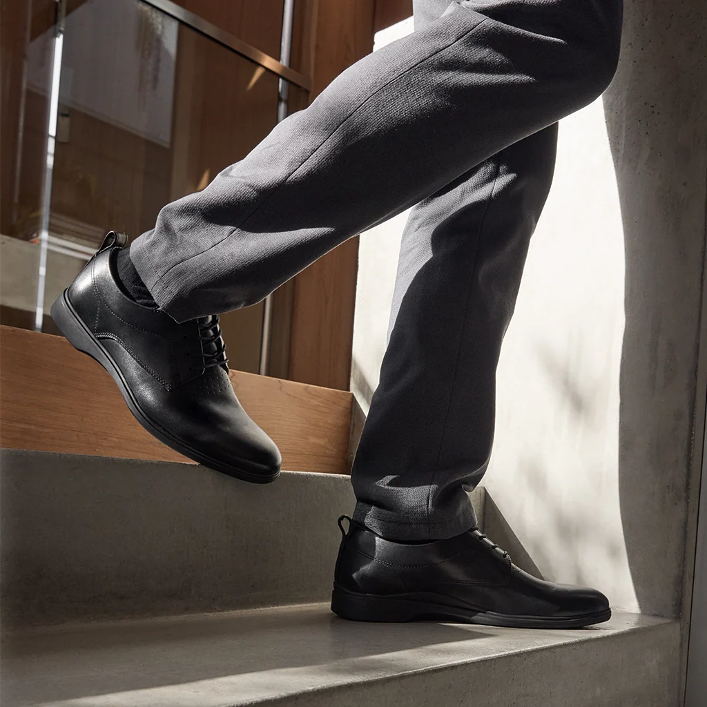 Amberjack The Original Obsidian black pilot dress oxford shoe, left side view, TSA-compliant lace-up | Lifestlye Walking down stairs