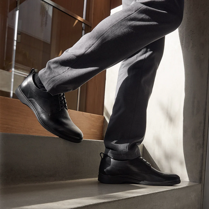 Amberjack The Original Obsidian black pilot dress oxford shoe, left side view, TSA-compliant lace-up | Lifestlye Walking down stairs