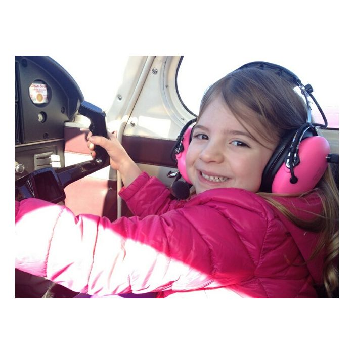 Young Girl Wearing Pilot USA PA‑1151ACG Pink Aviation Headset in Cockpit