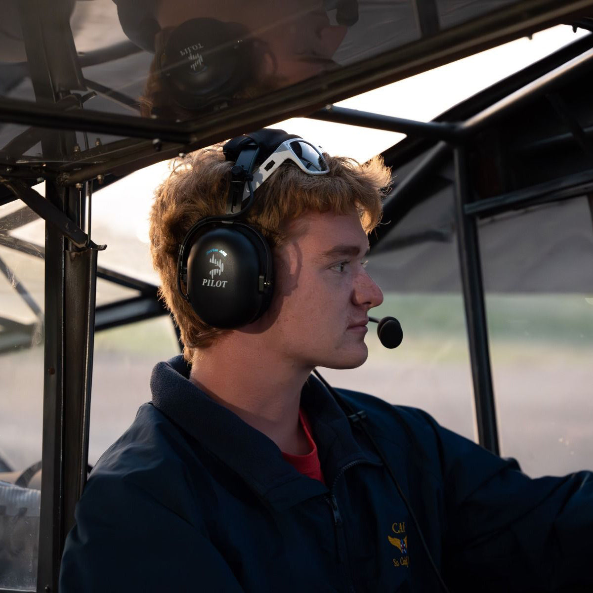Pilot wearing Pilot USA ProMax ANR Aviation Headset in cockpit