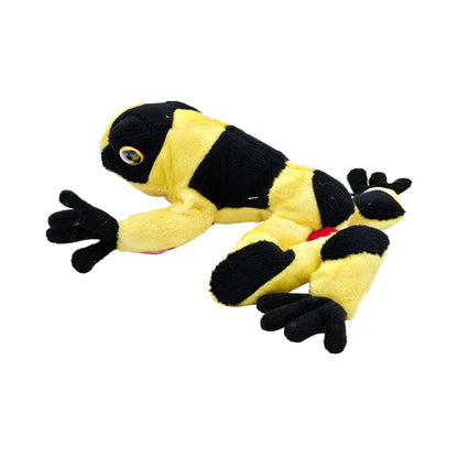 side view of yellow and black striped plush tree frog with splayed legs and black feet
