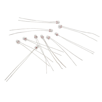 Ten Wamco 7152AS15 subminiature aircraft lamps with wire leads arranged on a white background