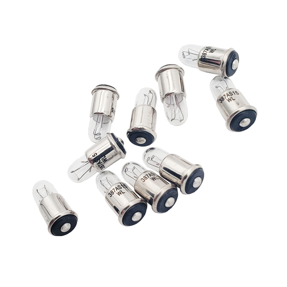 Ten Wamco WL-387AS15 subminiature aircraft lamps showing midget flange bases, stamped part numbers, and clear glass envelopes
