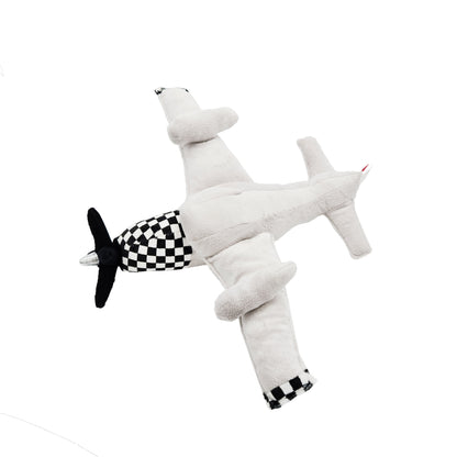 High-angle view of WowToyz P-51 Mustang plush airplane toy featuring gray body, black propeller, and checkerboard nose design.