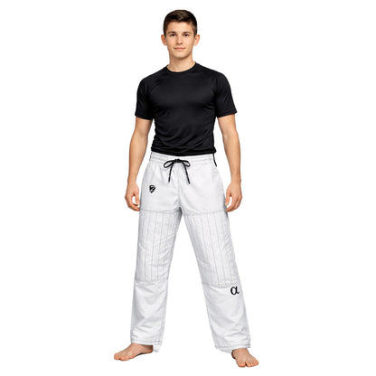 Person wearing a black t-shirt and white martial arts pants on a white background