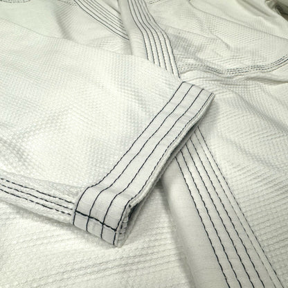 Zed Honra Women’s Alpha Gi – Close-Up of White BJJ Kimono Sleeve with Reinforced Stitching
