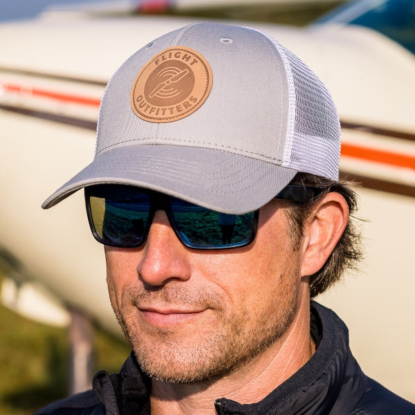 Flight Outfitters Cloud Cruiser Hat worn by pilot near aircraft