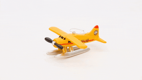 A view of the Flight Outfitters Seaplane Ornament, highlighting its durable resin construction and silver hanging ribbon.