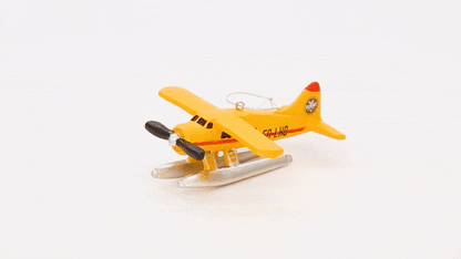 A view of the Flight Outfitters Seaplane Ornament, highlighting its durable resin construction and silver hanging ribbon.