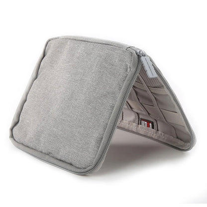 Gray travel watch and strap organizer standing open to reveal interior mesh and elastic