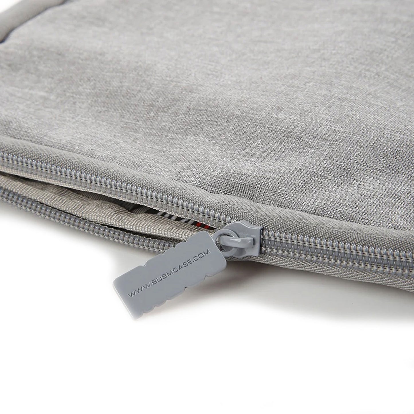 Close-up of durable zipper with branded pull tab on soft gray watch strap organizer pouch.