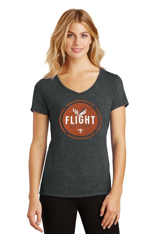 A woman standing while wearing the Flight Outfitters Women's Vintage V-Neck T-Shirt, emphasizing its tailored fit and versatile look.
