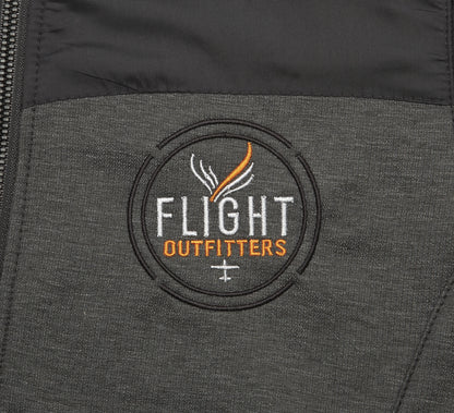 Close-up embroidered Flight Outfitters logo on Women's Kodiak Jacket – circular patch with white and orange text on gray fabric