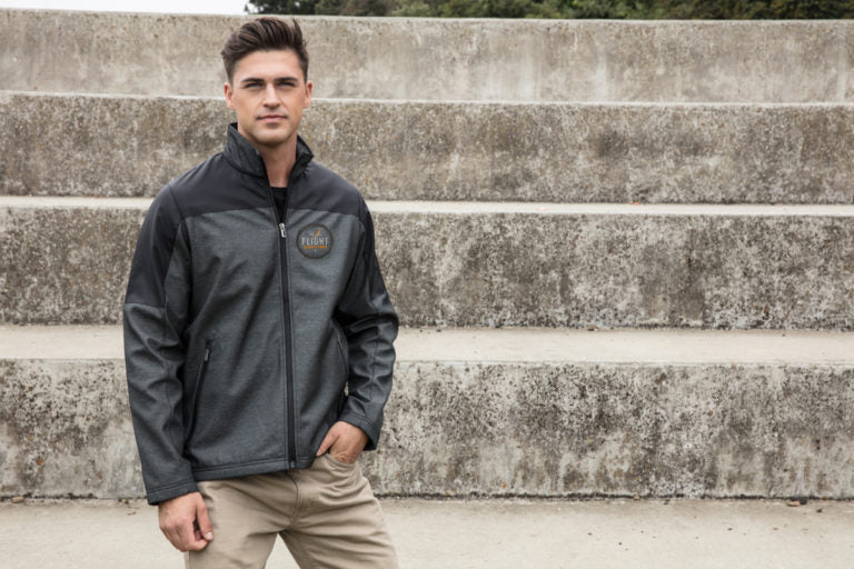 Lifestyle photo – man wearing Flight Outfitters Men's Kodiak Jacket standing outdoors with hand in pocket